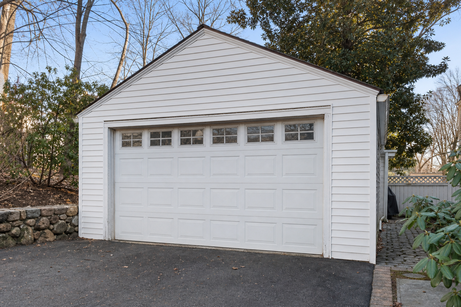 Suburban garage door in Belmont with visible wear on hardware